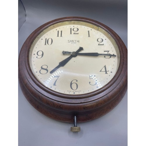 110 - A bakelite Smiths 8 Day Wall Clock with clockwork movements and assorted coloured glassware