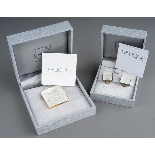 20 - Lalique - a Masque de Femme brooch, approx 3cm x 3cm; and a pair of ear clips, boxed with paperwork ... 