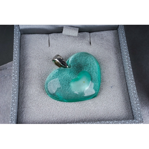 21 - Lalique - a green glass heart pendant, approx 3.5cm wide, on a silver necklet, with an extra green r... 