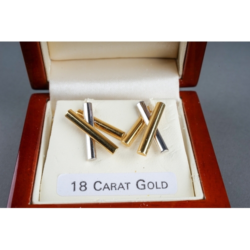 38 - A pair of 18ct bi-colour gold earrings, yellow and white gold batons, post and butterfly fittings, t... 