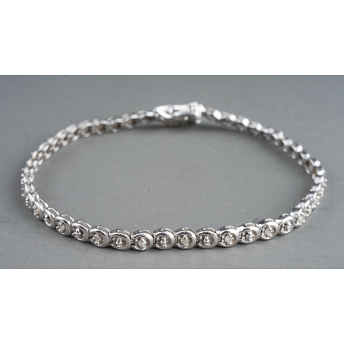 41 - A 9ct white gold and diamond line bracelet, the clasp stamped '0.25', approx 18cm long, gross weight... 