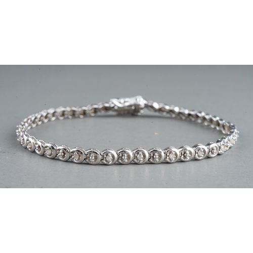 41 - A 9ct white gold and diamond line bracelet, the clasp stamped '0.25', approx 18cm long, gross weight... 