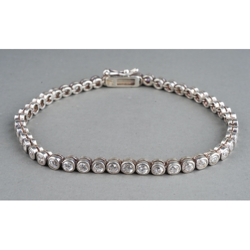 41 - A 9ct white gold and diamond line bracelet, the clasp stamped '0.25', approx 18cm long, gross weight... 