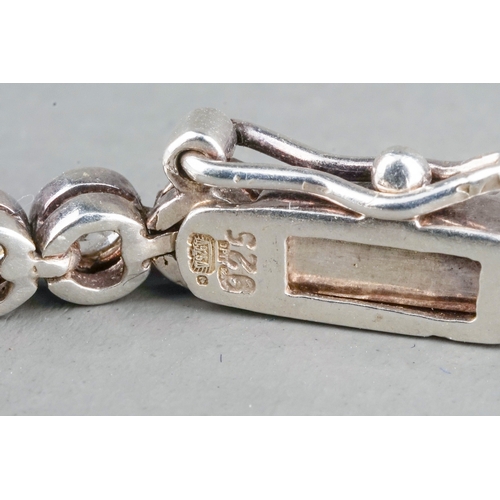 41 - A 9ct white gold and diamond line bracelet, the clasp stamped '0.25', approx 18cm long, gross weight... 