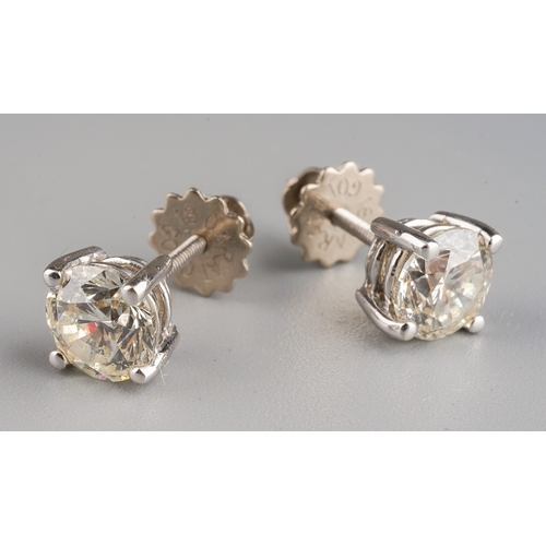 50 - A pair of 18k white gold and diamond solitaire earrings, each diamond in four-claw settings, estimat... 