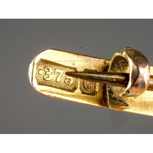 61 - A 9ct yellow gold bar brooch, probably made from a ring, monogrammed oval centre, approx 6.5cm long,... 