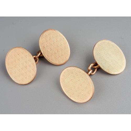 62 - A pair of 9ct rose gold oval cufflinks, engine turned detail, approx 17mm x 8mm, gross weight approx... 