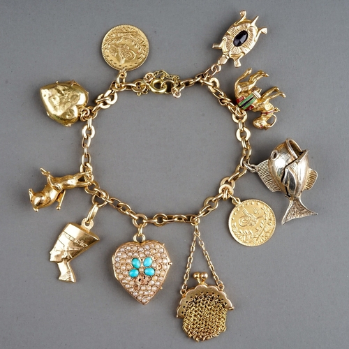 71 - A charm bracelet, suspending gold mesh purse stamped '18ct', Egyptian gold charms of camel and phara... 