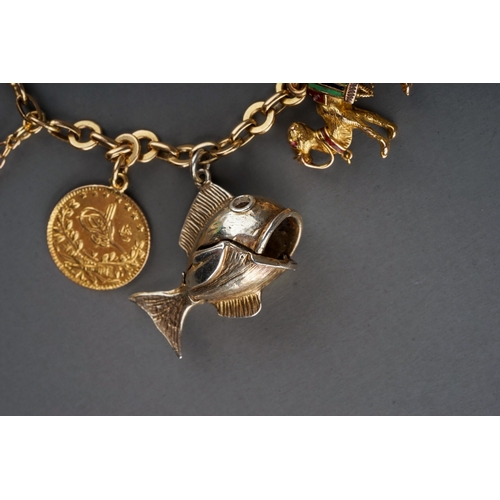 71 - A charm bracelet, suspending gold mesh purse stamped '18ct', Egyptian gold charms of camel and phara... 