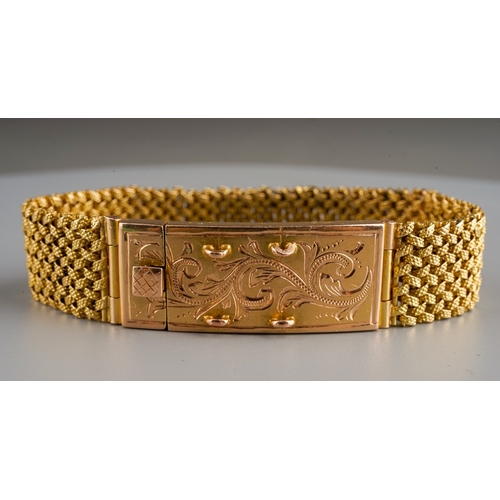 74 - A yellow gold bracelet, the textured mesh bracelet with large box clasp engraved with foliate swirls... 