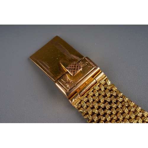 74 - A yellow gold bracelet, the textured mesh bracelet with large box clasp engraved with foliate swirls... 