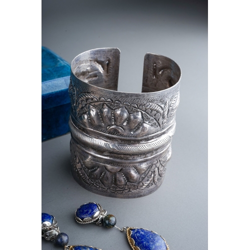 76 - Costume jewellery, including a large silver cuff, probably Egyptian; a set of silver and lapis lazul... 