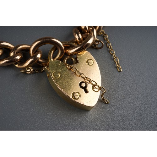 80 - Gold 15ct  heart shaped lock on a 9ct gold bracelet.  12.5g total weight