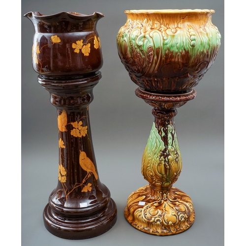 91 - A Bretby pottery jardiniere on stand together with a late 19th century majolica style jardiniere on ... 