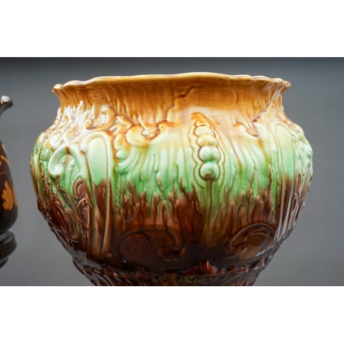 91 - A Bretby pottery jardiniere on stand together with a late 19th century majolica style jardiniere on ... 