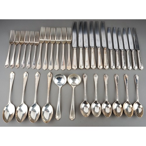 176 - A George V silver six piece / place flatware service comprising table forks, dessert forks, dessert ... 