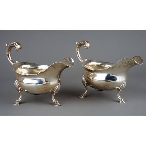 177 - A pair of George III silver sauceboats, plain oval bodies with wavy rim on three shell and hoof feet... 