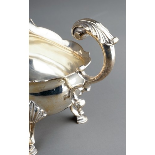 177 - A pair of George III silver sauceboats, plain oval bodies with wavy rim on three shell and hoof feet... 