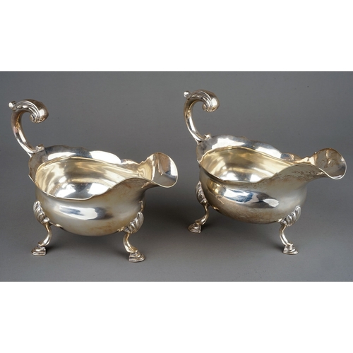 177 - A pair of George III silver sauceboats, plain oval bodies with wavy rim on three shell and hoof feet... 