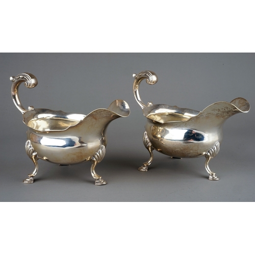 177 - A pair of George III silver sauceboats, plain oval bodies with wavy rim on three shell and hoof feet... 