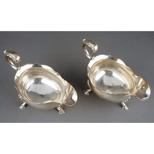 177 - A pair of George III silver sauceboats, plain oval bodies with wavy rim on three shell and hoof feet... 