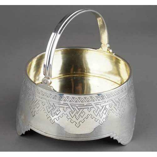 181 - A 19th Century Russian silver circular sugar bowl / basket with swing handle, the body engraved with... 