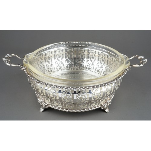 182 - A George V silver circular reticulated two handled bowl, rope twist borders with geometric pattern b... 