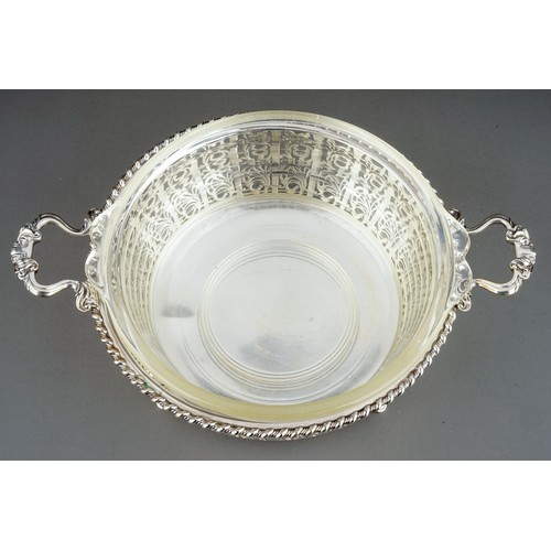 182 - A George V silver circular reticulated two handled bowl, rope twist borders with geometric pattern b... 