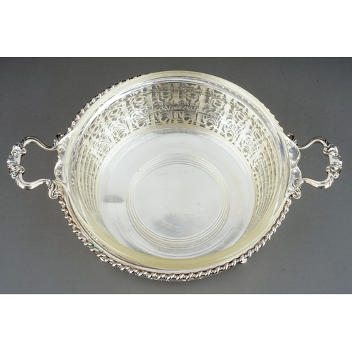 182 - A George V silver circular reticulated two handled bowl, rope twist borders with geometric pattern b... 