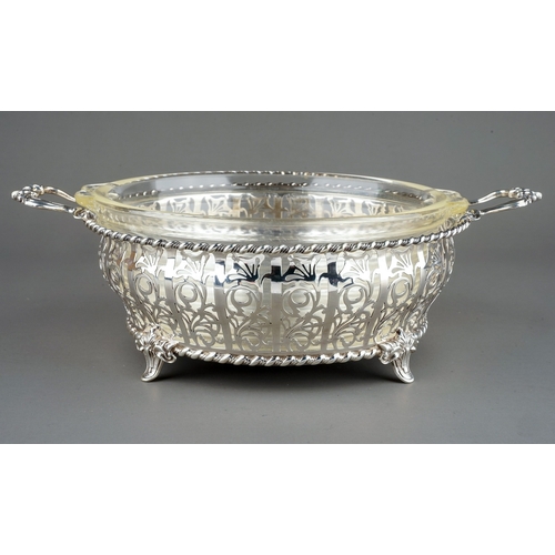 182 - A George V silver circular reticulated two handled bowl, rope twist borders with geometric pattern b... 