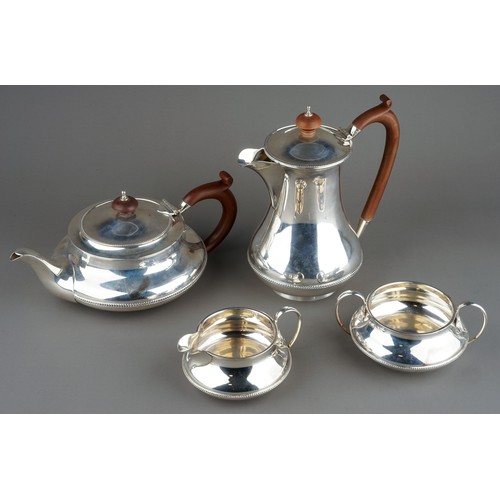 187 - A George V silver four piece tea service comprising teapot, sugar bowl, milk jug and hotwater jug, p... 