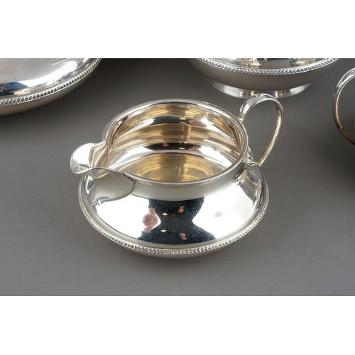 187 - A George V silver four piece tea service comprising teapot, sugar bowl, milk jug and hotwater jug, p... 