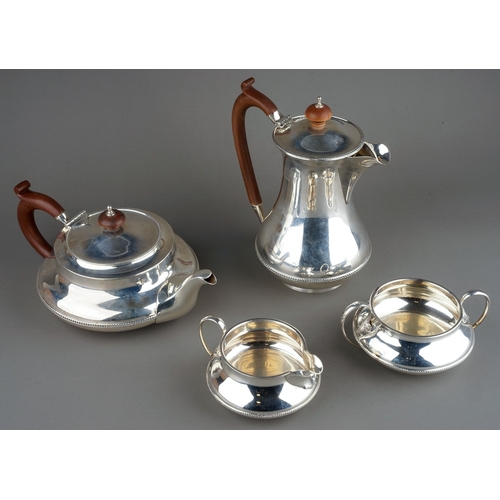 187 - A George V silver four piece tea service comprising teapot, sugar bowl, milk jug and hotwater jug, p... 