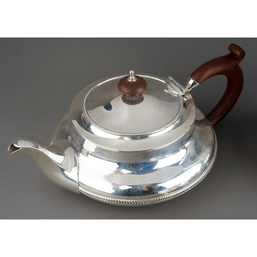 187 - A George V silver four piece tea service comprising teapot, sugar bowl, milk jug and hotwater jug, p... 