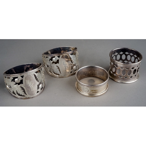 208 - A pair of Edwardian bright cut engraved silver napkin rings, with thistle decoration and central eng... 