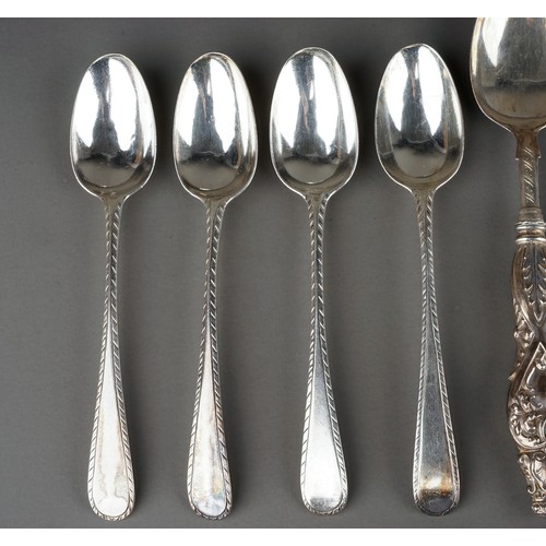 219 - A collection of silver flatware including Hanoverian table spoons, sugar nippers, teaspoons, butter ... 