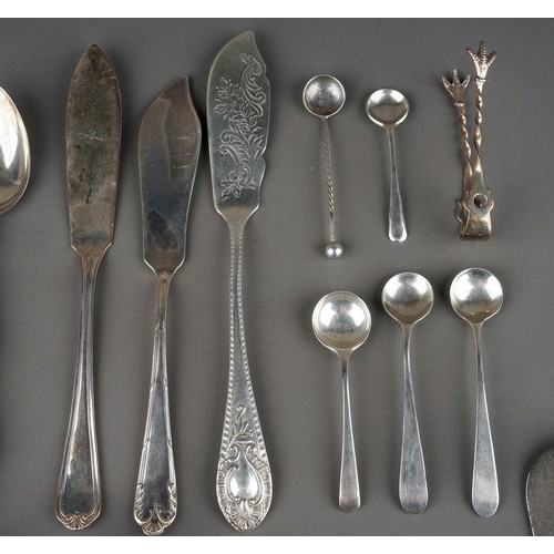 219 - A collection of silver flatware including Hanoverian table spoons, sugar nippers, teaspoons, butter ... 