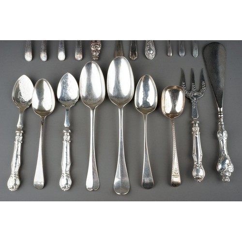 219 - A collection of silver flatware including Hanoverian table spoons, sugar nippers, teaspoons, butter ... 