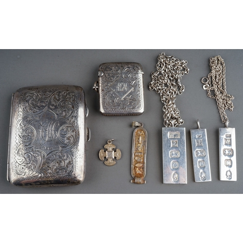 221 - A silver cigarette case; a silver vesta; three silver ingots; a Egyptian silver pendant; silver chai... 