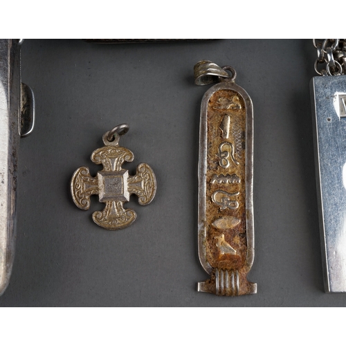 221 - A silver cigarette case; a silver vesta; three silver ingots; a Egyptian silver pendant; silver chai... 