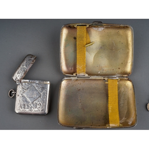 221 - A silver cigarette case; a silver vesta; three silver ingots; a Egyptian silver pendant; silver chai... 