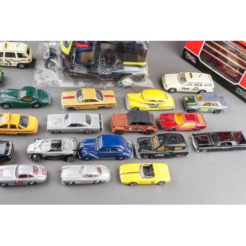 298 - Assorted loose die cast model cars mainly Matchbox together with boxed fire engines, buses, a Vangua... 