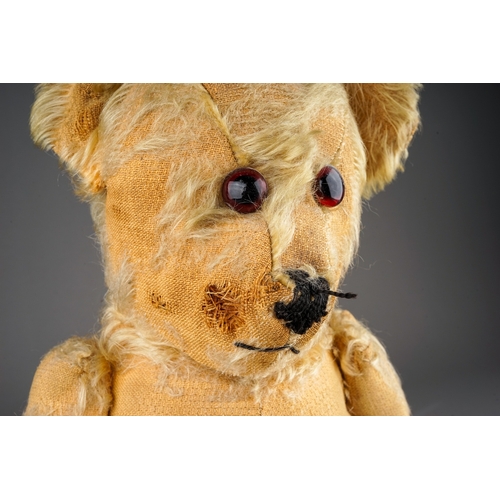 305 - An early 20th Century straw filled Bear with glass eyes, black snout, articulated arms, blonde mohai... 