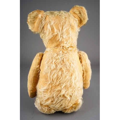 305 - An early 20th Century straw filled Bear with glass eyes, black snout, articulated arms, blonde mohai... 