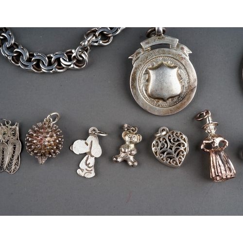 314 - A collection of silver and white metal jewellery, including chains, fobs, a curb-link bracelet set w... 