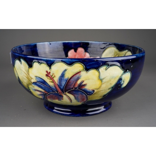 347 - Moorcroft bowl in Hibiscus pattern on a dark blue ground  by William Moorcroft, signed to base in gr... 