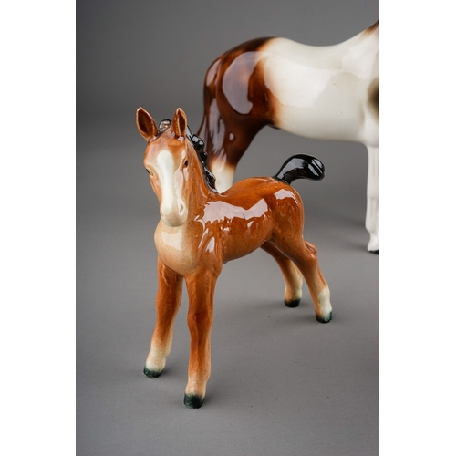 355 - A collection of ceramic horses to include: a Melba china skewbald and five various Beswick horses in... 