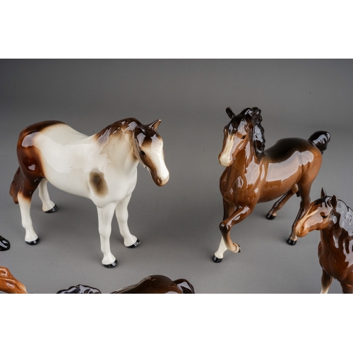 355 - A collection of ceramic horses to include: a Melba china skewbald and five various Beswick horses in... 