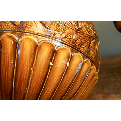 401 - A late Victorian Burmantofts monumental earthenware amber glazed jardiniere on stand, the large bowl... 