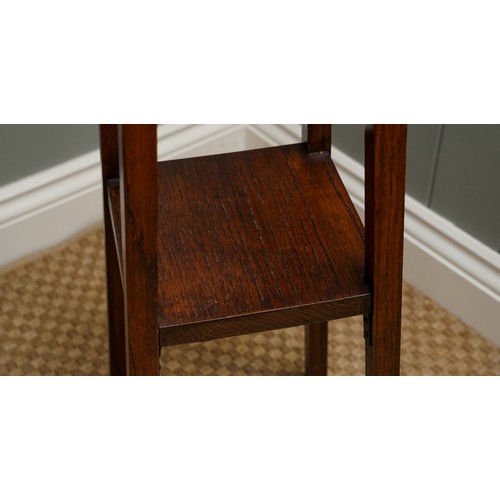 402 - An Arts & Crafts Liberty style oak jardiniere stand, plain body above tapering supports, the upper s... 